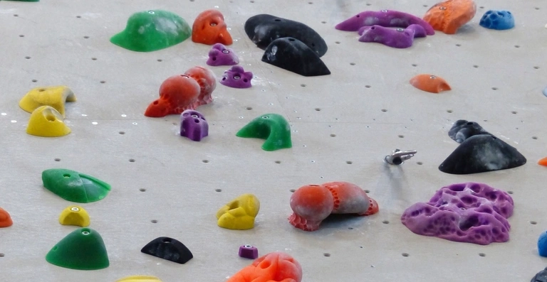 Colorful indoor rock climbing holds on a wall